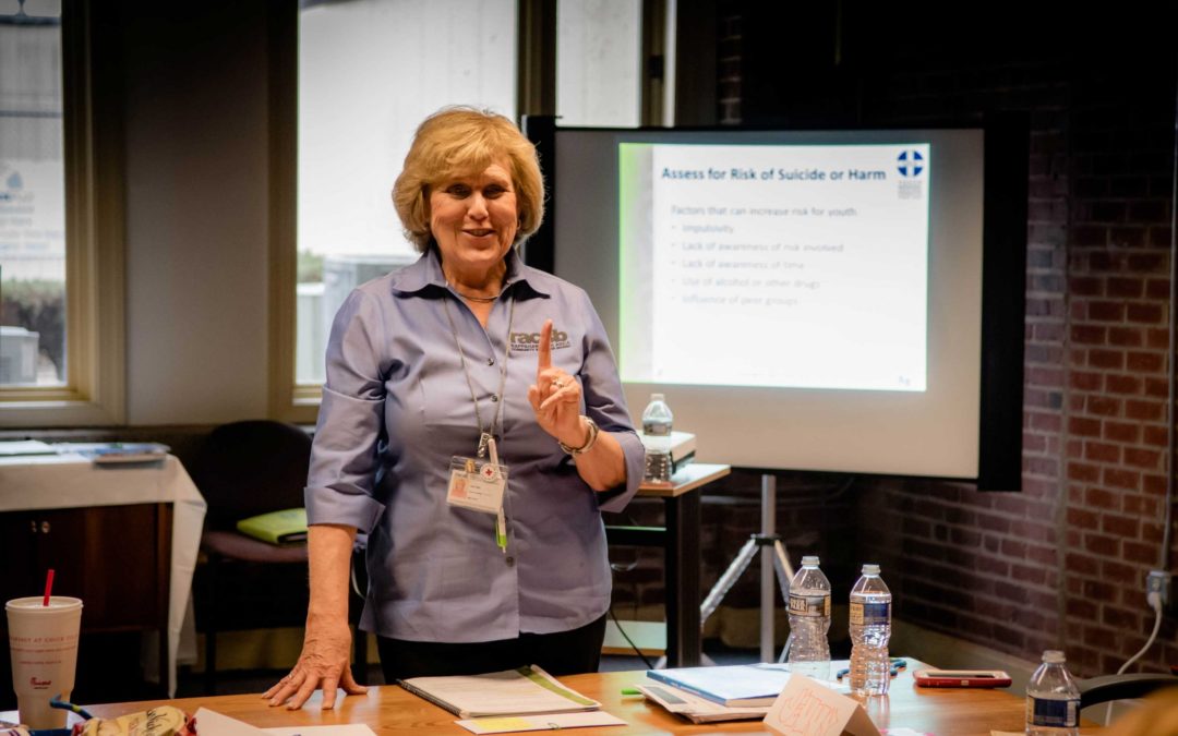 A woman teaching a Mental Health First Aid class
