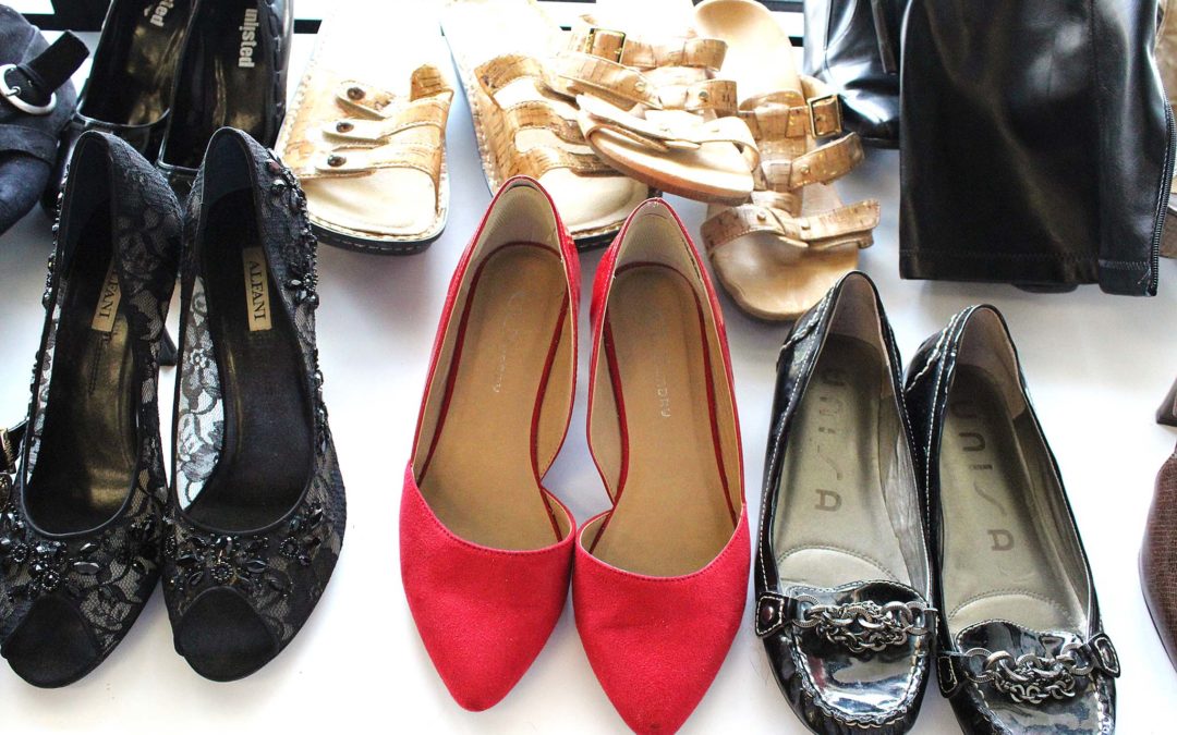 A pair of red high heels in a collection of shoes