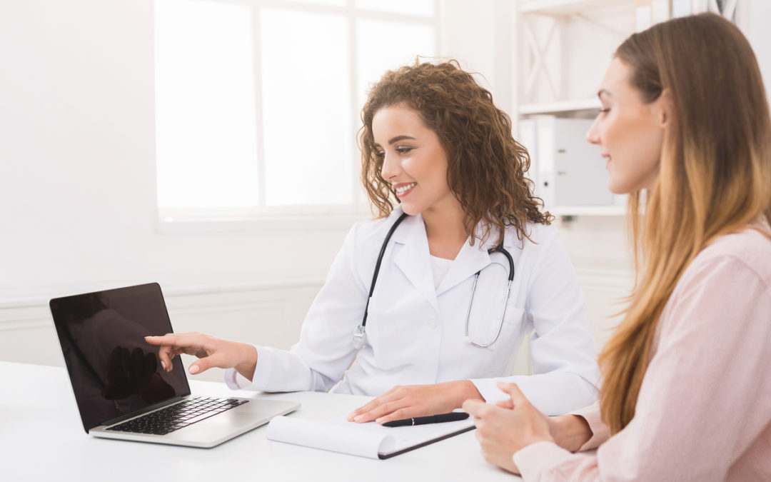 Female doctor using laptop and electronic medical record system, reading patient's health care and personal information, copy space