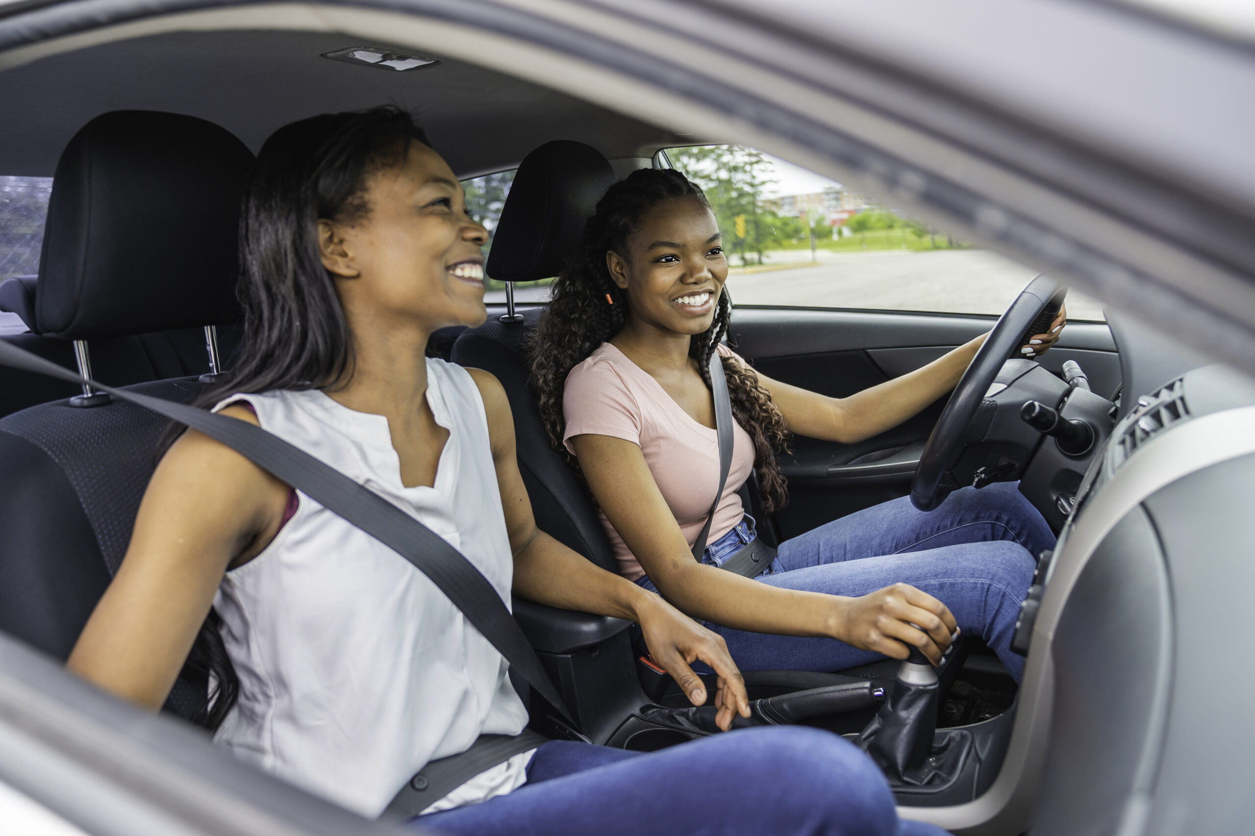 African American mother and teenage daughter embracing