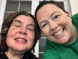 Two women smile for a picture