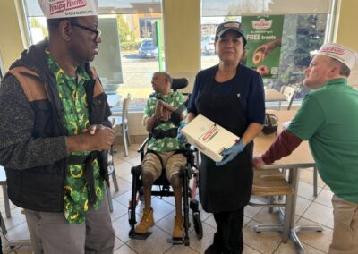 A group of men wearing green at Krispy Kreme Donuts