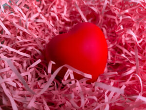 Red heart surrounded by pink crinkle paper 