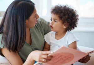 Mother reading book to toddler
